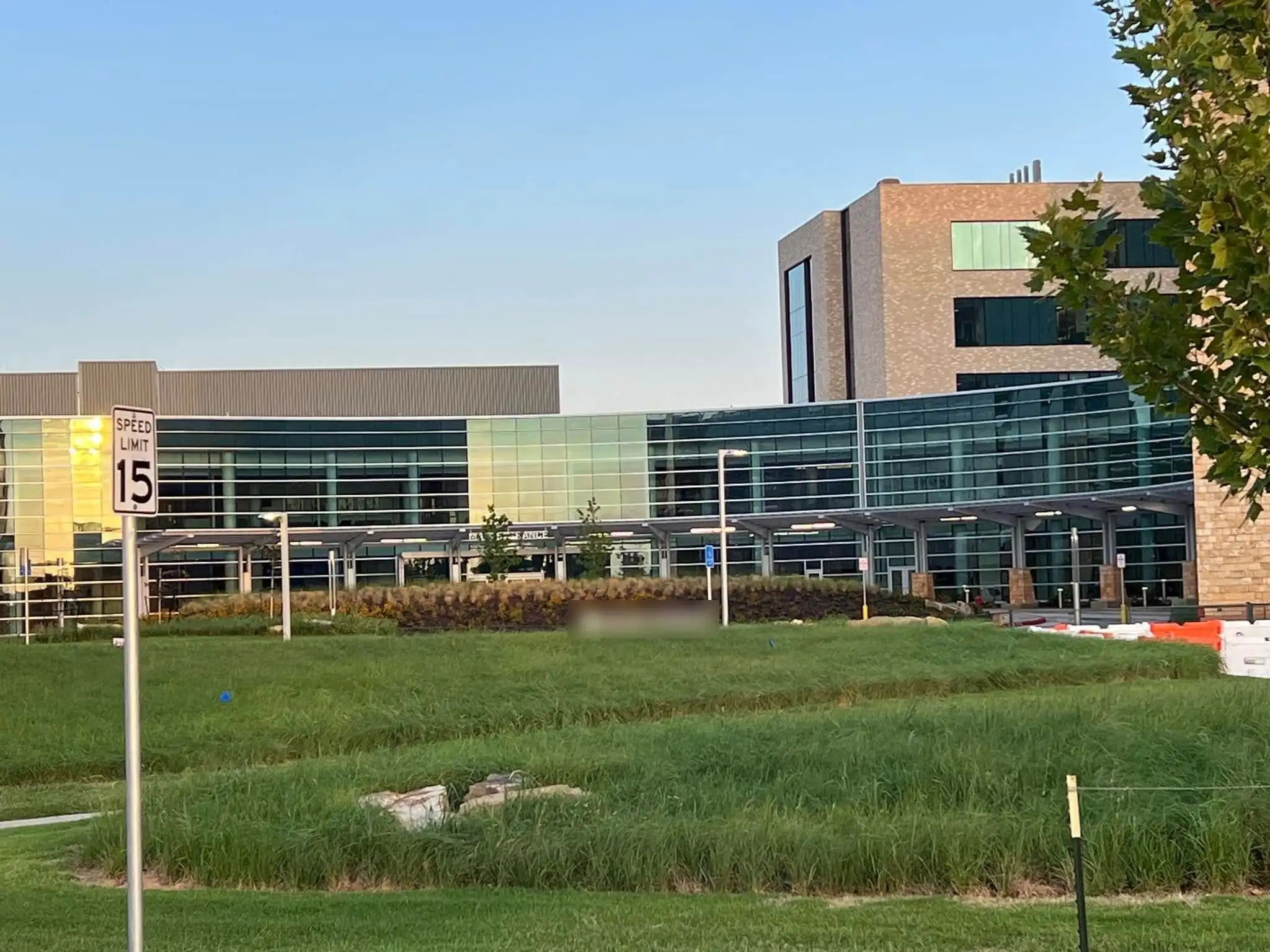 Hospital campus landscaping with native grasses and planted berms