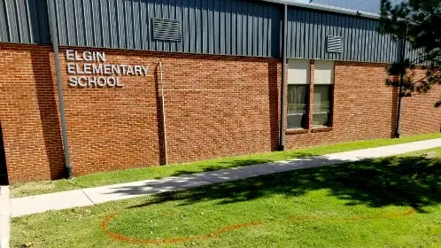 School building bed before landscaping, with plain turf and no plantings